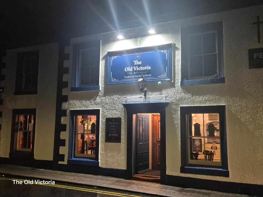 a building with a blue sign on the side of it at The Old Victoria in Penrith
