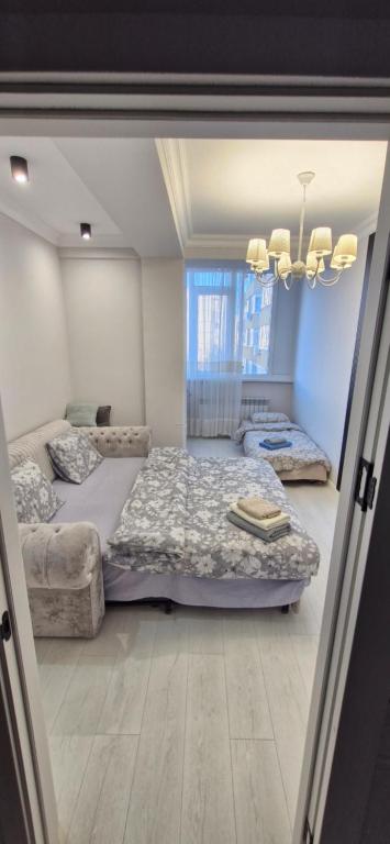 a bedroom with a large bed and a couch at Vila in Chişinău