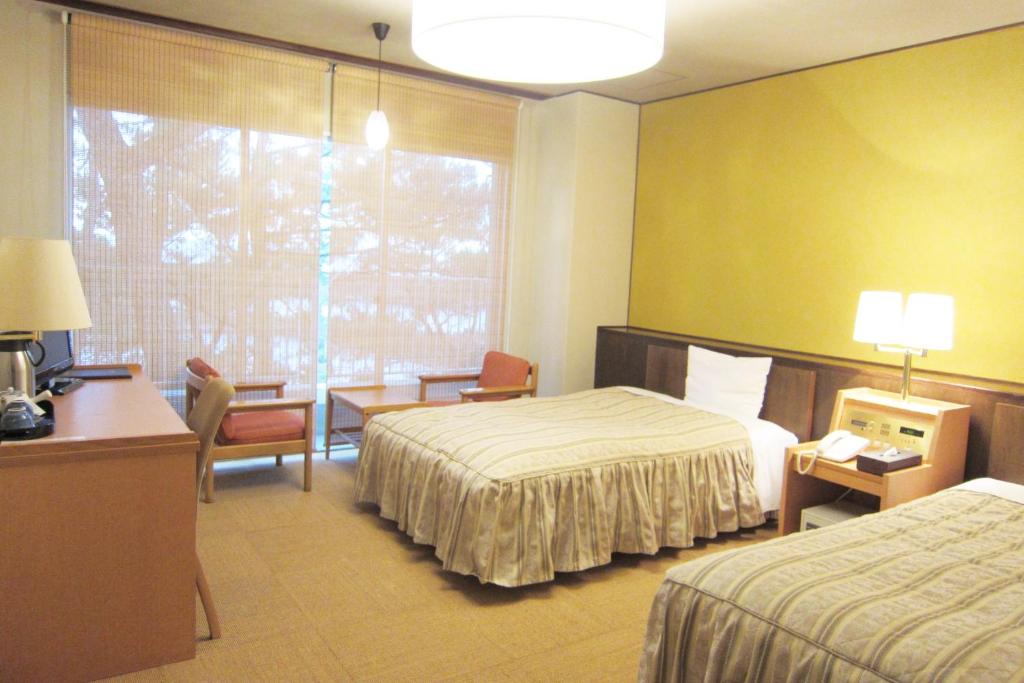 Postel nebo postele na pokoji v ubytování Hotel Axia Kushikino