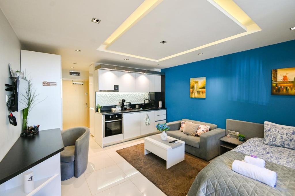 a living room with a couch and a kitchen at N9 Studentski Loft in Sofia