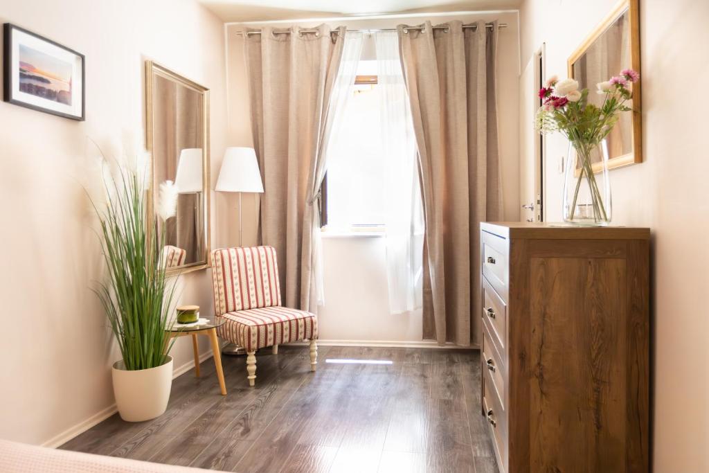a bedroom with a dresser and a window and a chair at Gloria apartment Rovinj - Heart of Old town - Steps from Sea in Rovinj