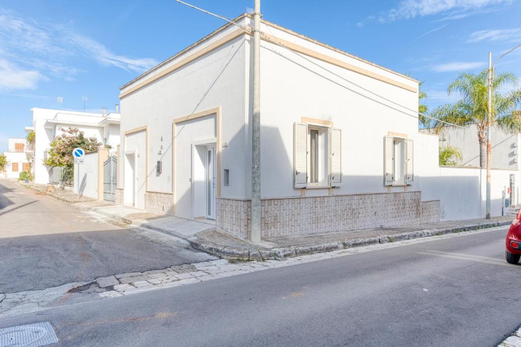 a white building on the side of a street at Mauricarol Residences in Acquarica del Capo