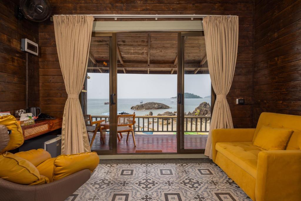 a living room with a view of the ocean at The Ark Comforts in Palolem