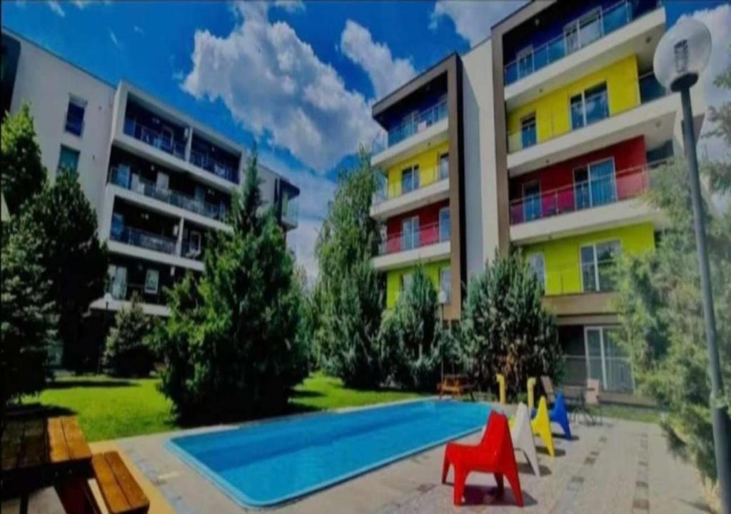 a swimming pool in front of a building at Airport Residence in Otopeni