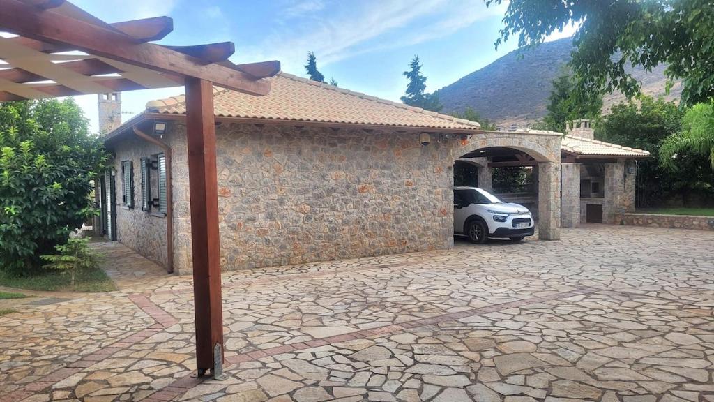 a car parked outside of a building with a driveway at Villa with private pool and stunning sea view in Galaxidhion