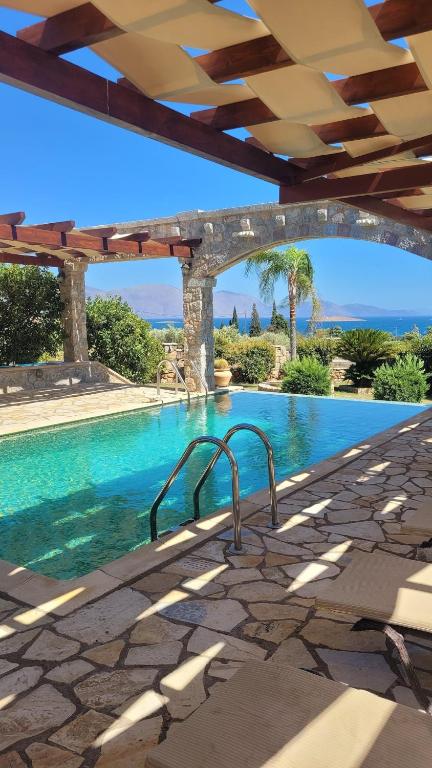 a swimming pool with a view of the ocean at Villa with private pool and stunning sea view in Galaxidi