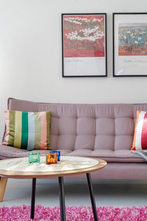 a living room with a couch and a coffee table at Aurora Atelier Design Apartment in Rovaniemi