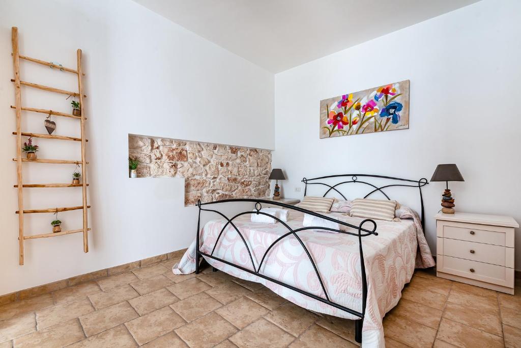 a bedroom with a bed and a dresser and a shelf at Helios Vacanze in Conversano