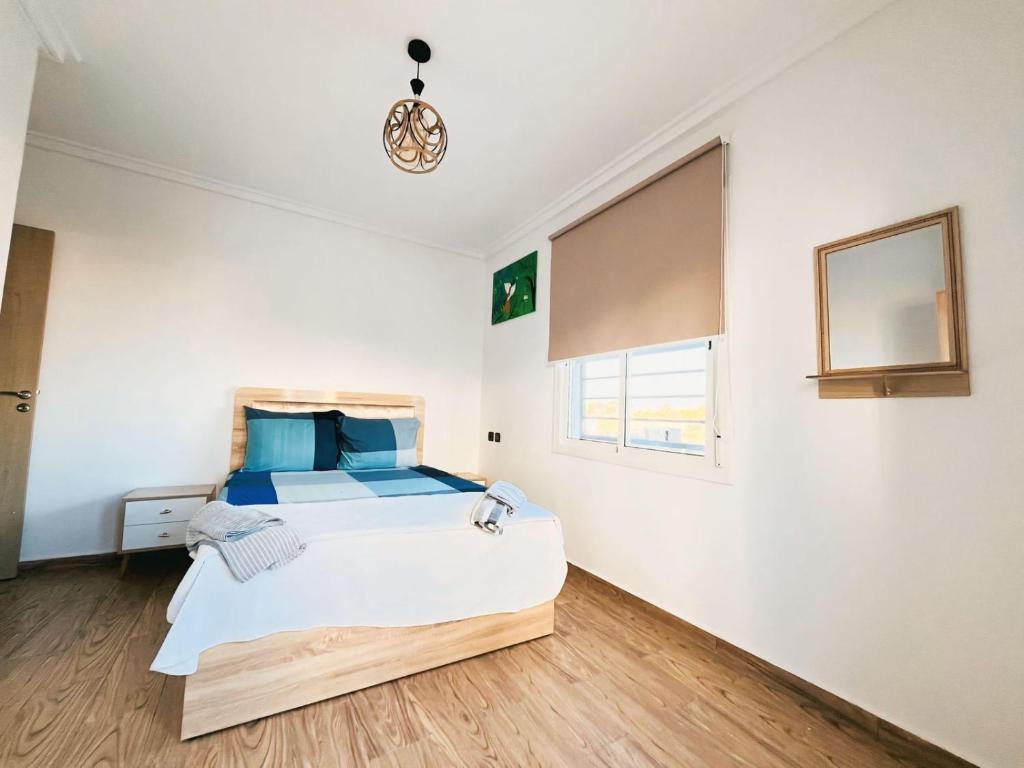 Postel nebo postele na pokoji v ubytování bel appartement à la plage des nations