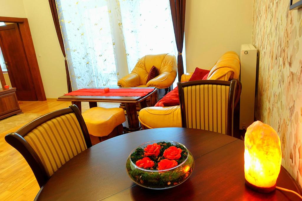 a dining room with a table with a bowl of fruit on it at Tatra Apartment Palace Hill with angels and sauna in Poprad