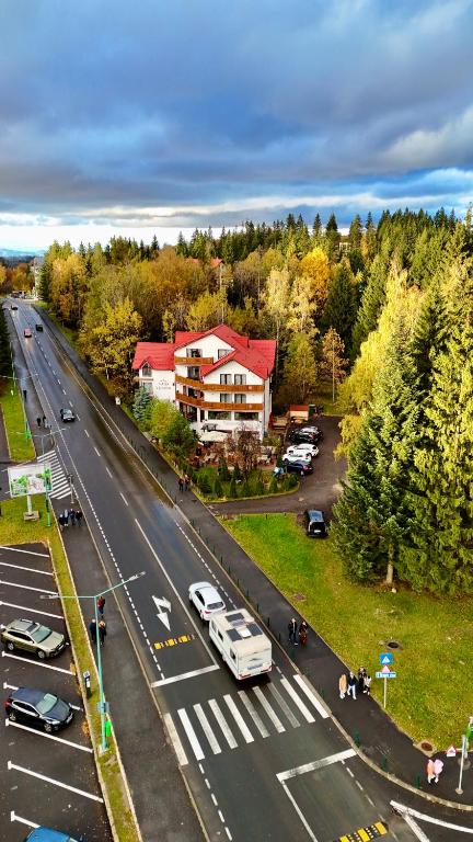 an aerial view of a highway with a building and cars at Casa Vlasin in Poiana Brasov