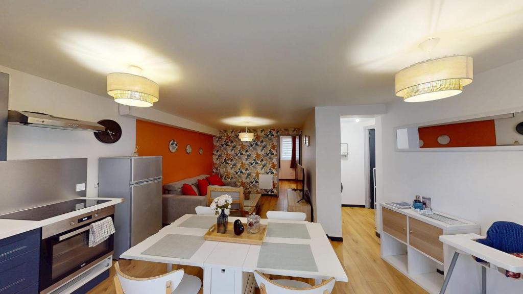 a kitchen and living room with a table and chairs at T2 Cozy & Elegant, 5 min walk to Nausicaá in Boulogne-sur-Mer