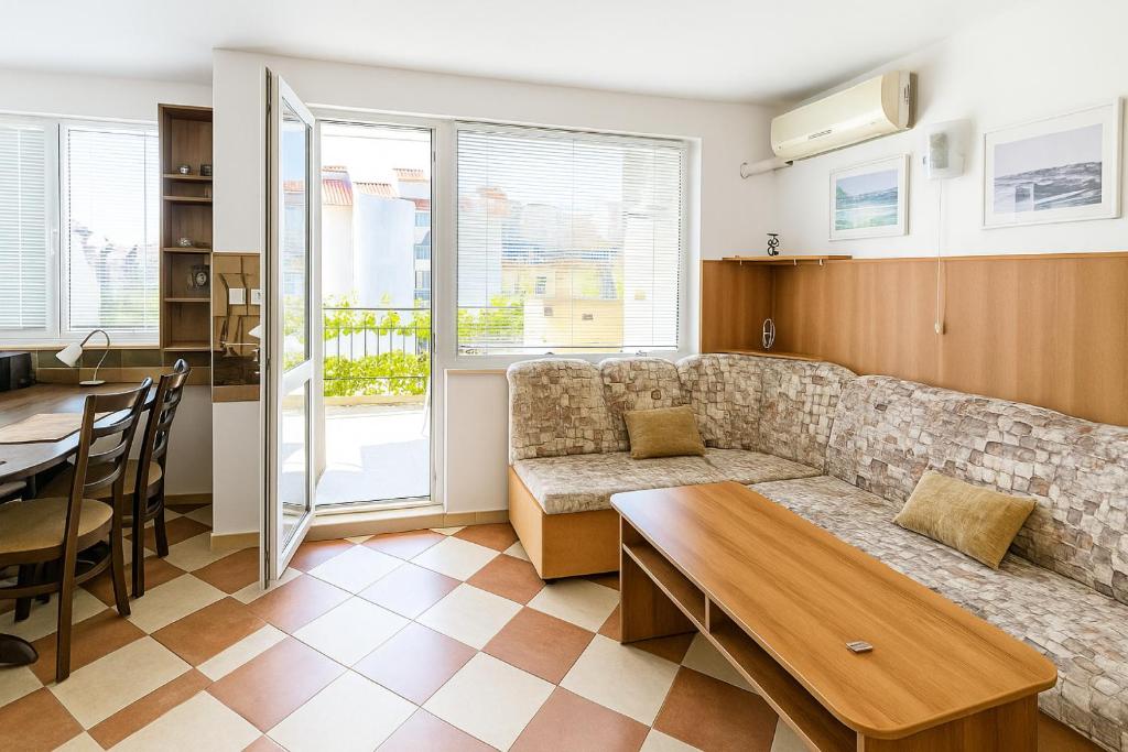 a living room with a couch and a table at Family 2BDR Apartment in the City Center in Sveti Vlas