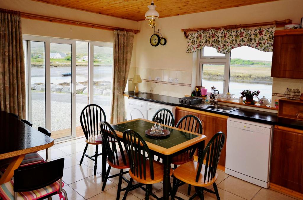 a kitchen with a table and chairs in a room at Cottage 216 - Roundstone in Roundstone