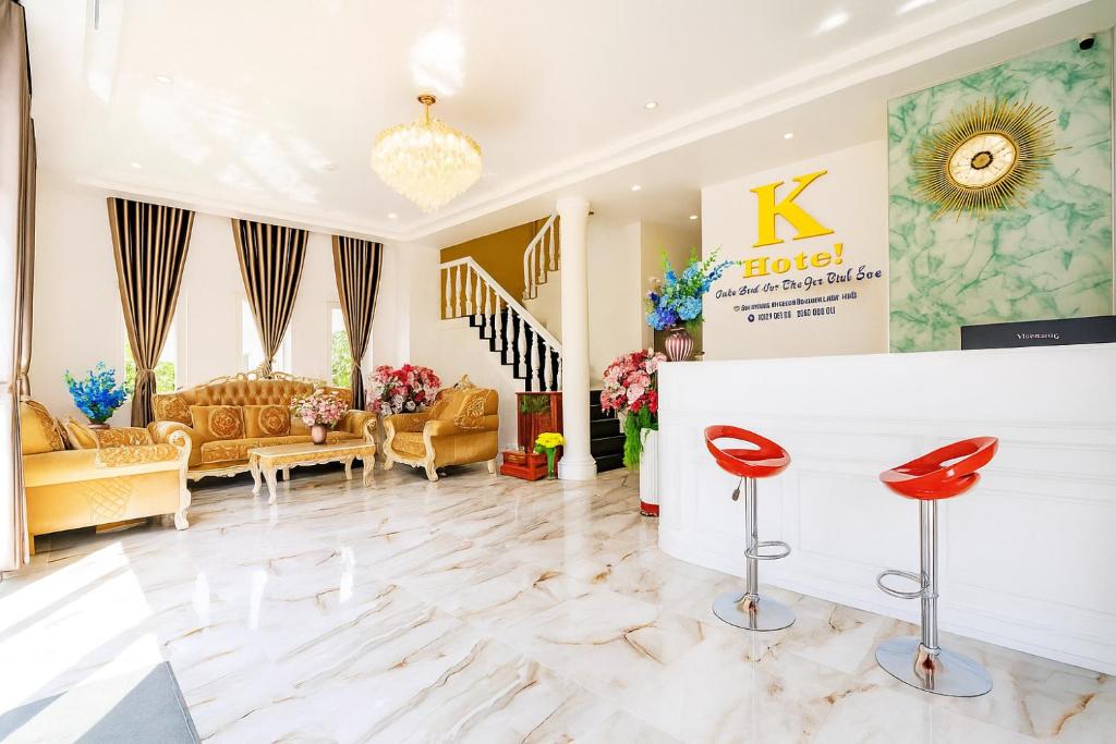 a large living room with red chairs and a couch at K Hotel Phú Quý in Cu Lao Thu