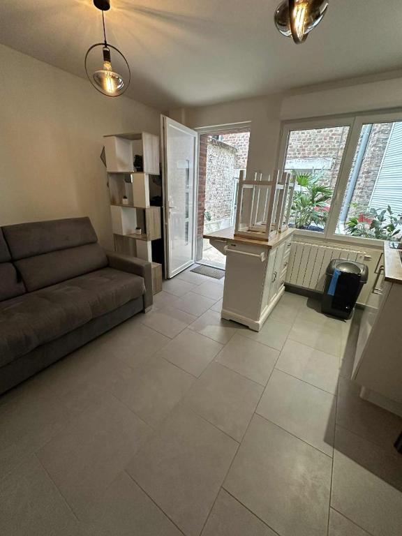 a living room with a couch and a table at Studette Peronne Centre in Péronne