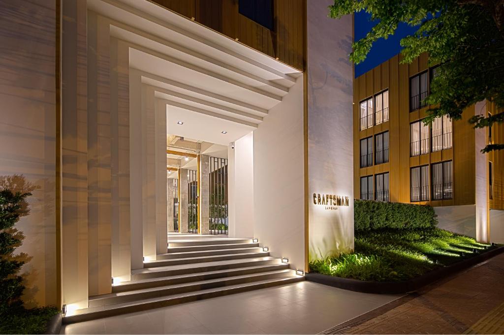 a hallway leading to a building with lights at Craftsman Bangkok in Bangkok