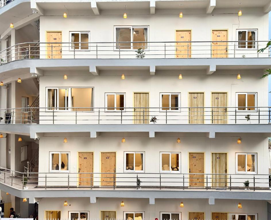 a building with a lot of windows at Zuna Stayz Tapovan Rishikesh in Rishīkesh