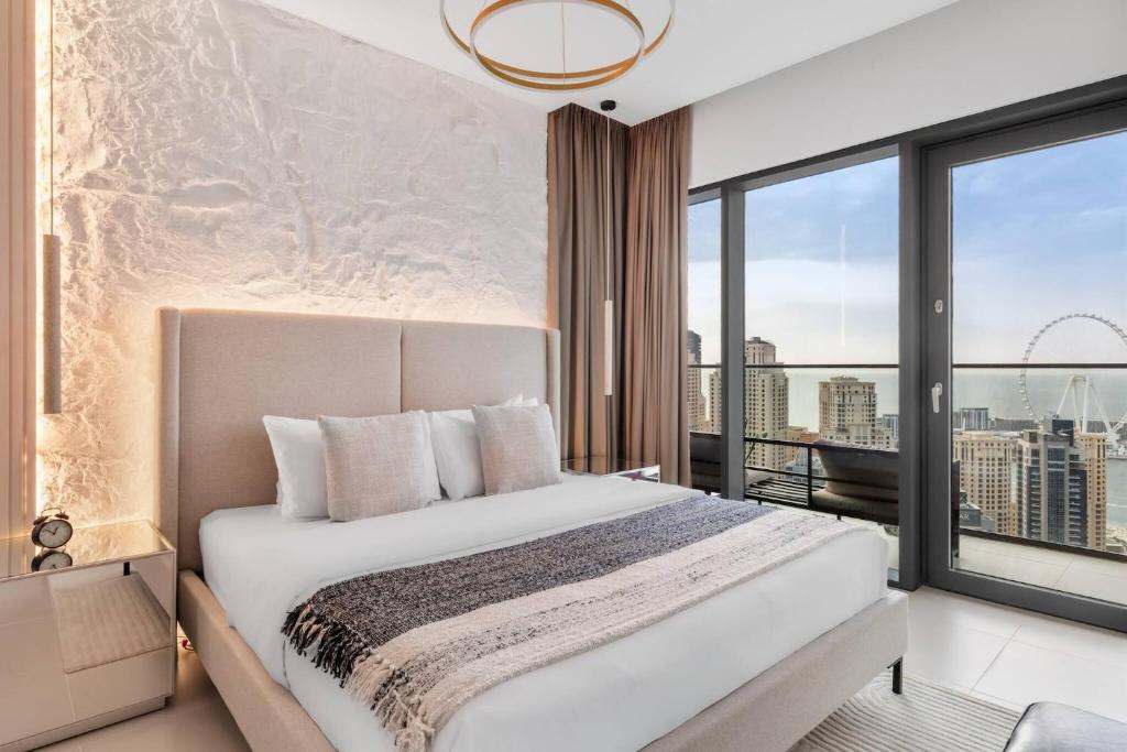 a bedroom with a bed and a large window at Novity Luxury Vida Marina 2BR Sea View 40th Floor in Dubai