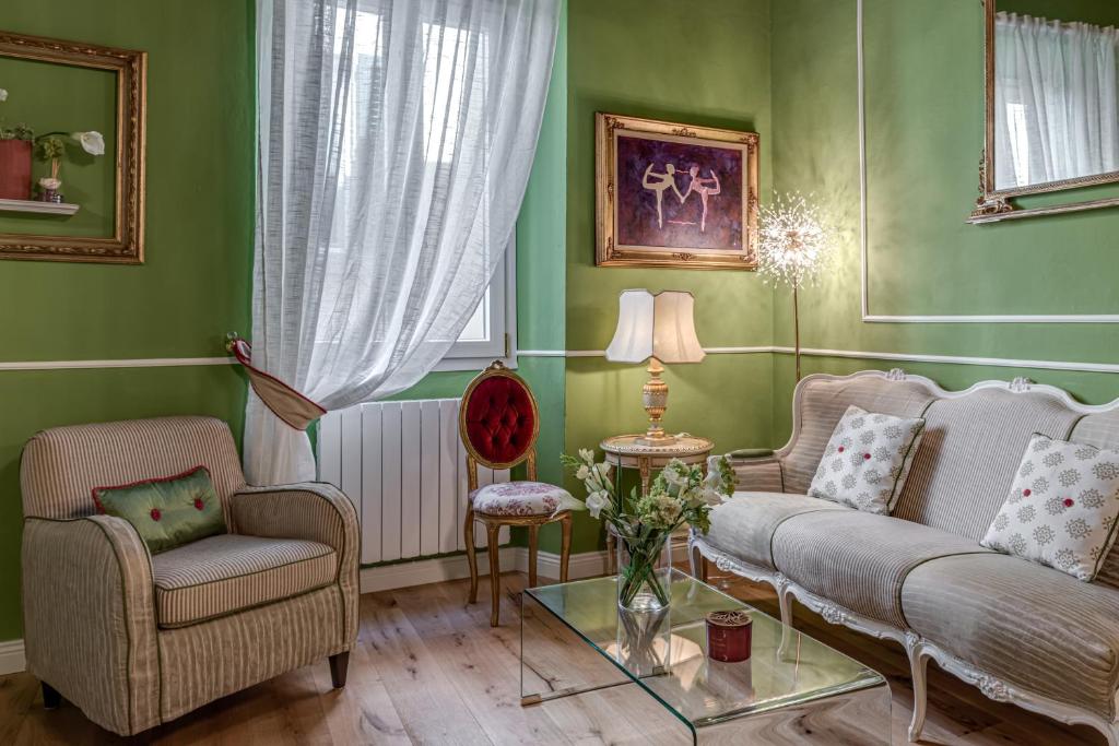 a living room with two chairs and a couch at Passera Royal Suite in Florence