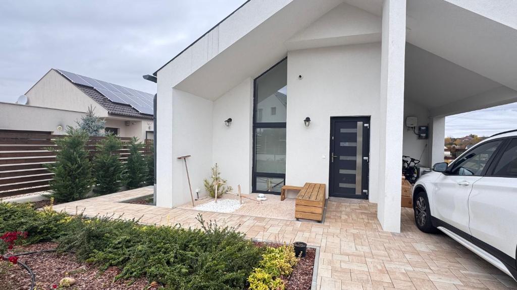 a white car parked in front of a white house at EtyekZen in Etyek