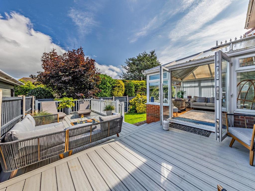 a deck with a couch and a gazebo at 4 Bed in Llandudno 89703 in Deganwy