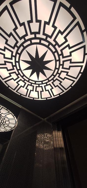 a ceiling with a clock on top of a building at ABC Apartments in Korçë