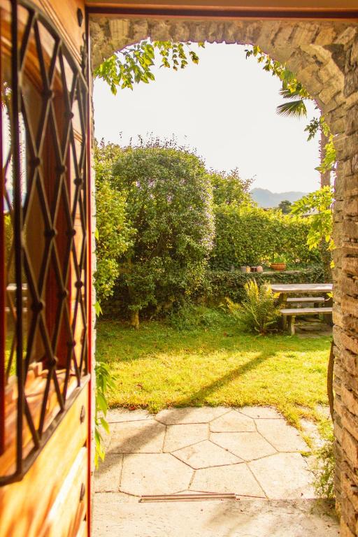 an open door leading to a yard with a patio at Villa dei Muralti- 2 free parkings in Muralto