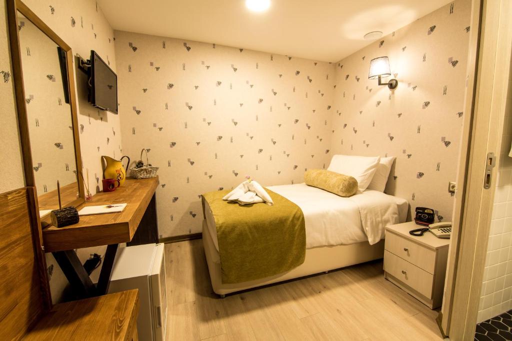 Postel nebo postele na pokoji v ubytování Kuzen Otel