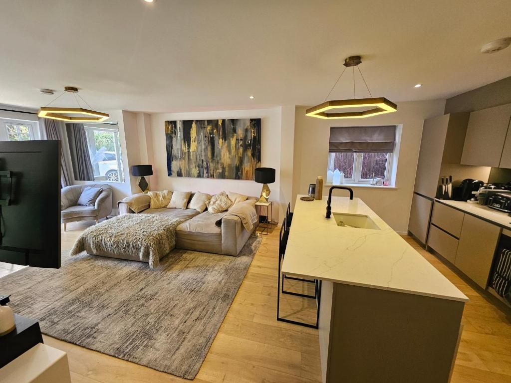 a large living room with a couch and a kitchen at Luxury 2 double bedroom Apt in the heart of Purley in Purley