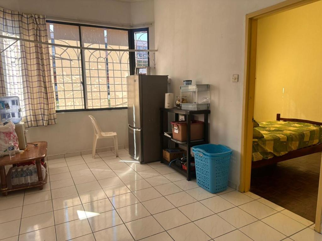 a kitchen with a refrigerator in a room at Sweet home Beverly hills in Penampang
