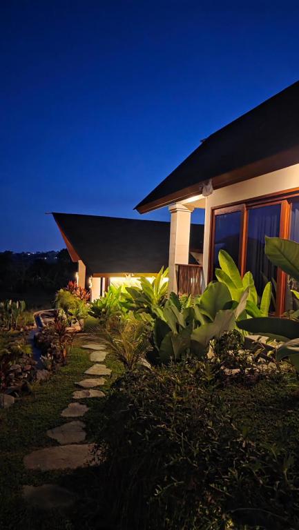 a house with a pathway in front of a building at INNerpeace Bali in Darmasaba