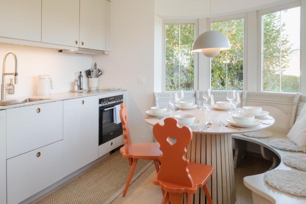 a kitchen with a table with dishes on it at Design-Apartment am Chiemsee in Rimsting
