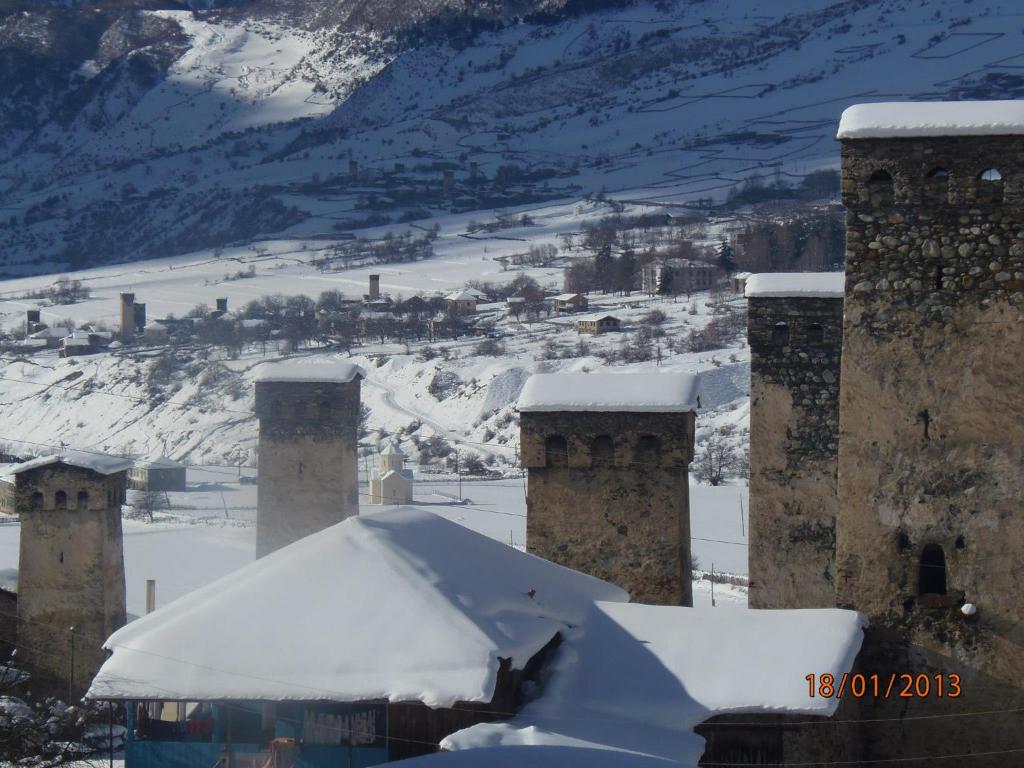 a building with snow on top of it at Vodo's Guesthouse in Chvabiani
