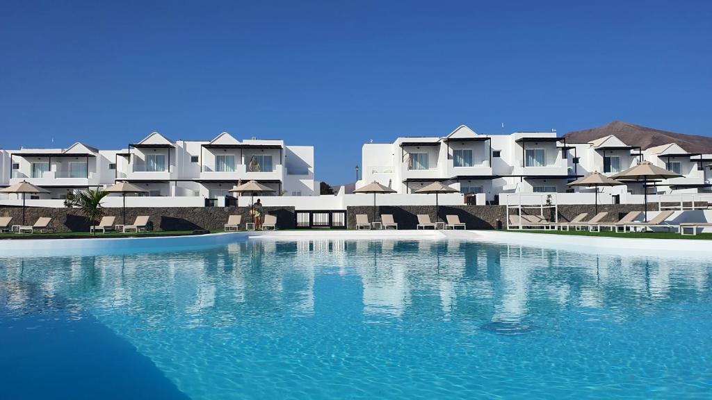 a large swimming pool in front of a resort at Serena del Mar by LIVVO in Playa Blanca