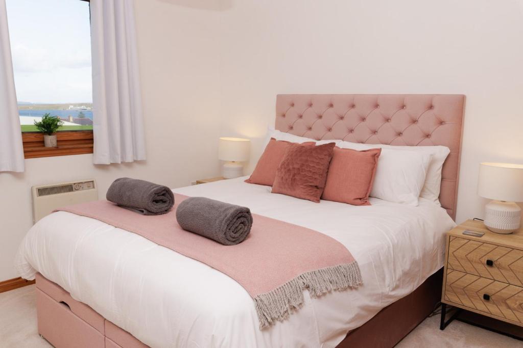 a bedroom with a large bed with two pillows on it at The Sound Rest, Lerwick in Lerwick