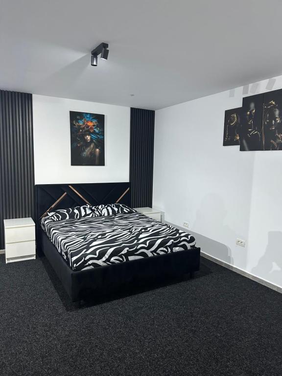 a bedroom with a black and white bed in a room at Home No 7 