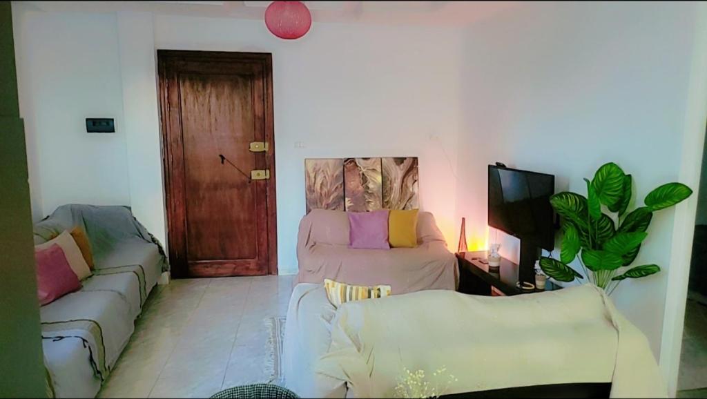 a living room with two couches and a tv at Sony in Kelibia