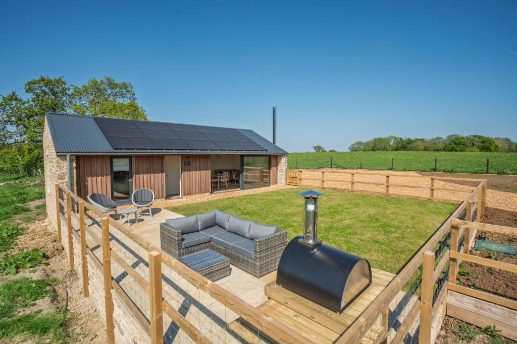 a house with a wooden fence and a patio at Hillbyre in Bath