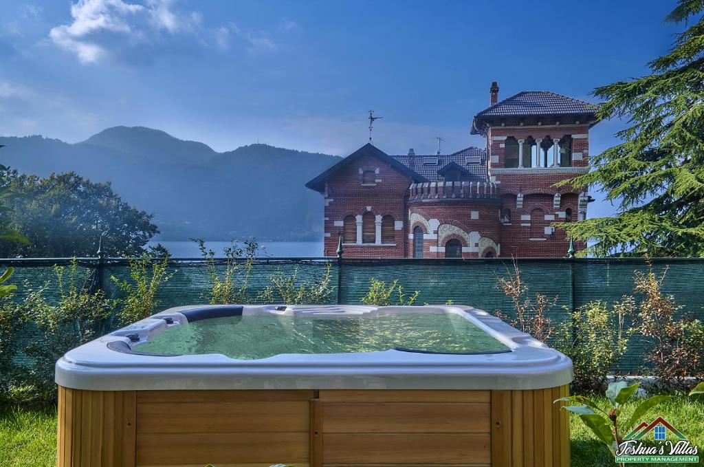a hot tub in front of a house at APT in Villa Bianca with Pool and air conditioning in Lierna