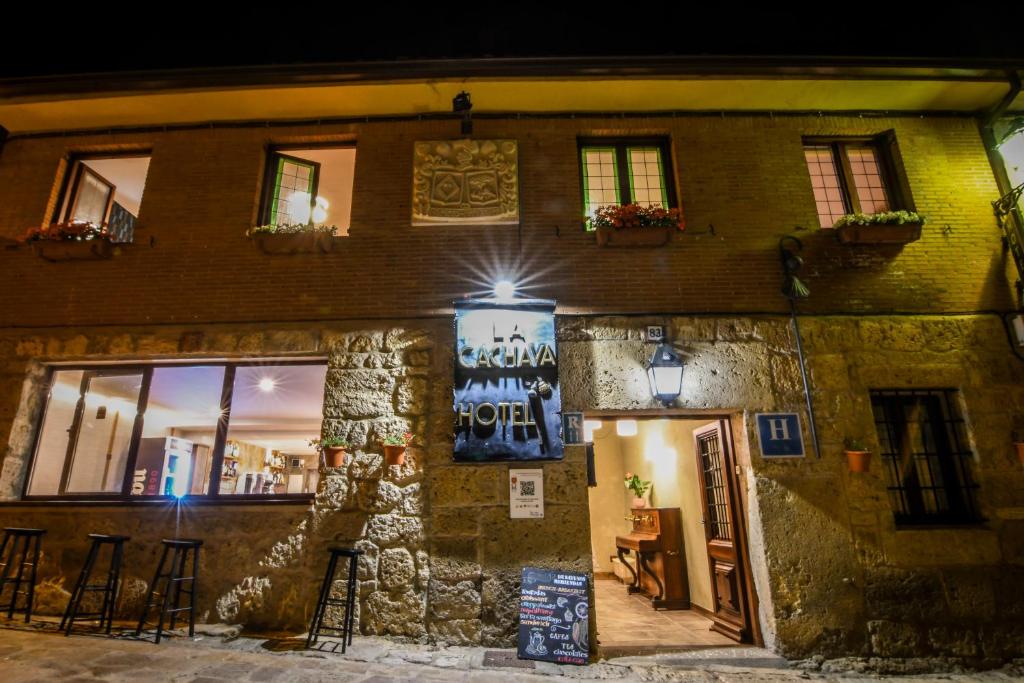 a building with a sign on the side of it at La Cachava in Castrojeriz