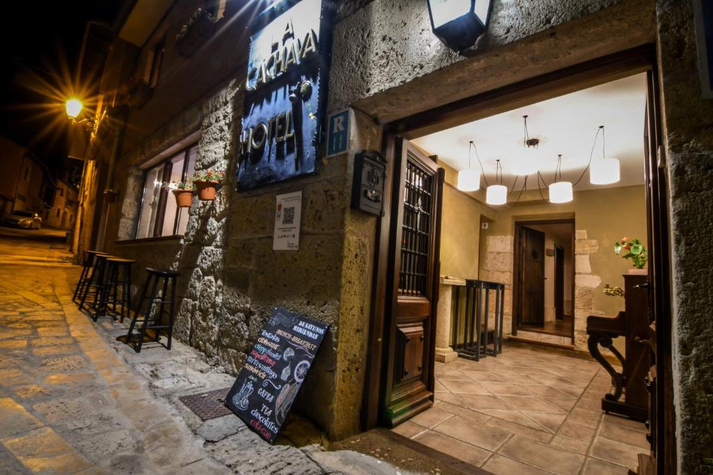 a store with a sign on the side of a building at La Cachava in Castrojeriz