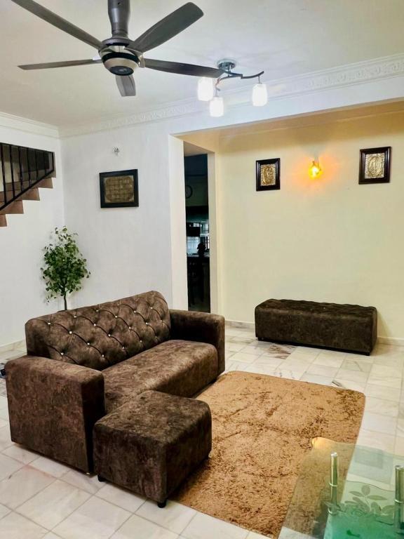 a living room with a couch and a table at Ribat Homestay in Gerik