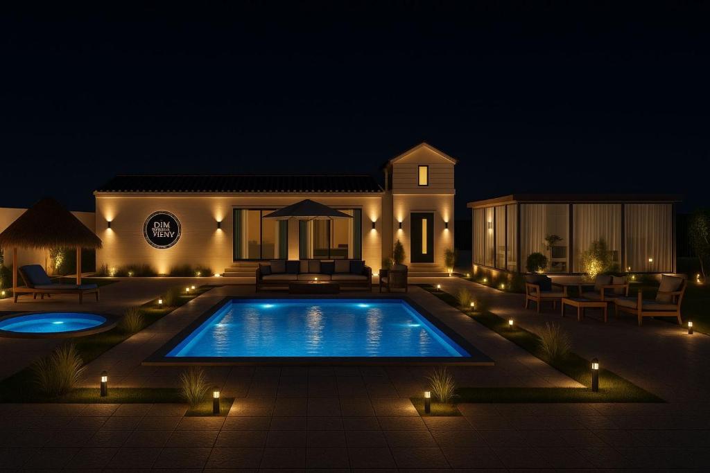 a house with a swimming pool at night at Deem view in Al Ain