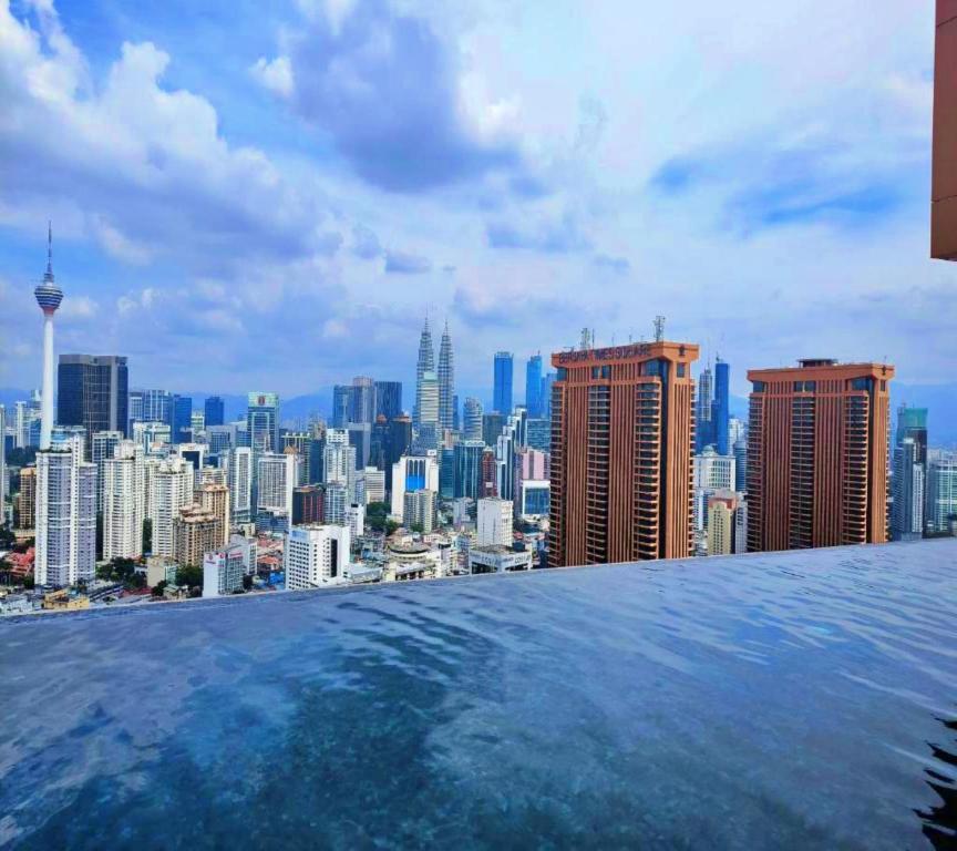 a view of a city skyline from a swimming pool at Lucentia Suites klcc by SkyPool in Kuala Lumpur