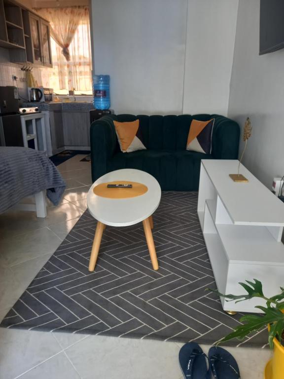 a living room with a table and a couch at Tulivu Homes in Meru