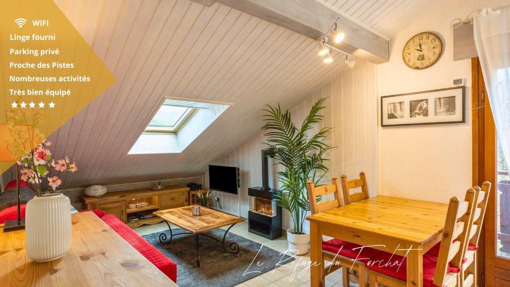 a living room with a table and a dining room at Le Refuge du Forchat in Bellevaux