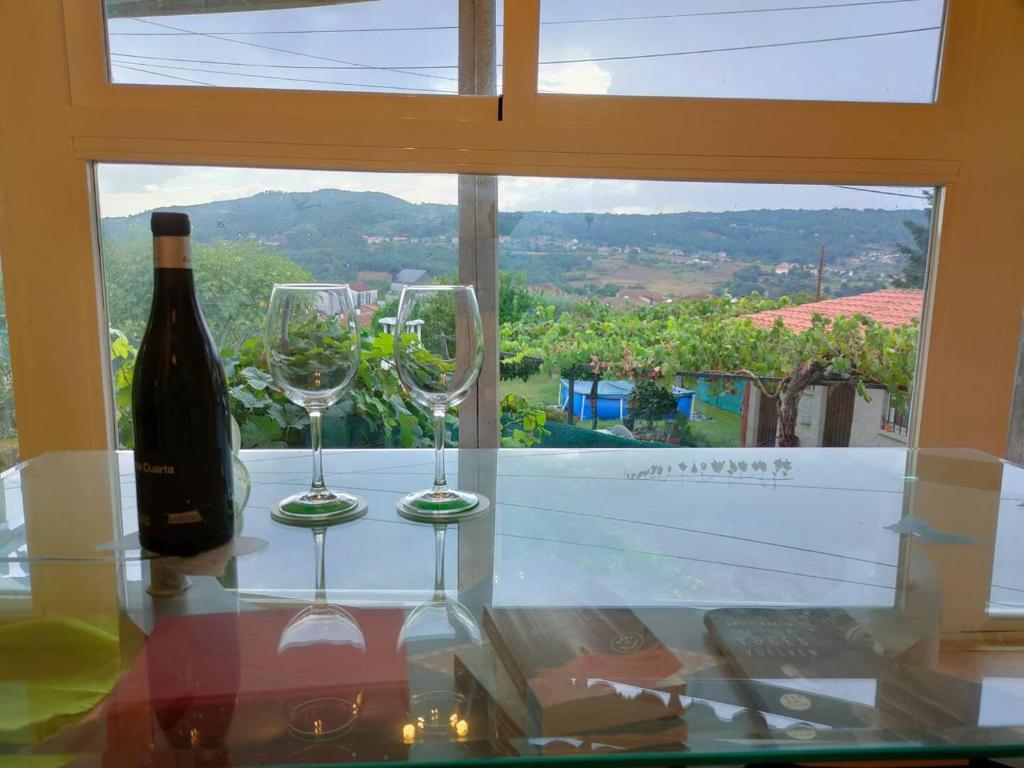 a bottle of wine and two glasses on a table at Casa Diego in Melias