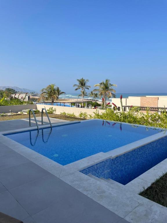 a swimming pool in front of the beach at Golden Dawn Villa in As Sīfah