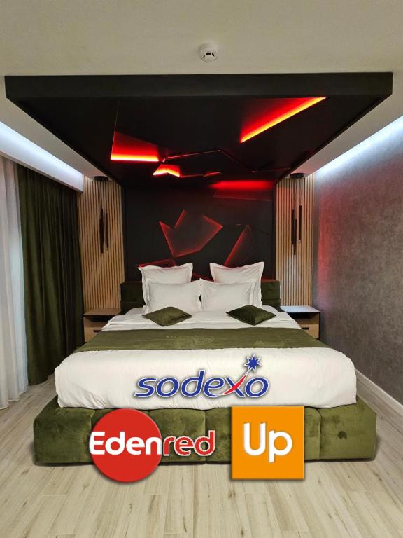 a hotel room with a large bed with red lights at MONARC Boutique ApartHotel - SELF CHECK-IN in Iaşi